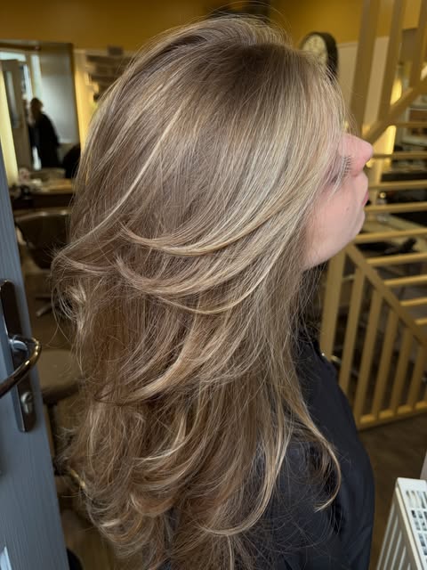 Layered blonde hair styled at Bottega