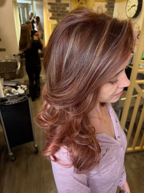 Copper-red layered hair with a curled finish at Bottega